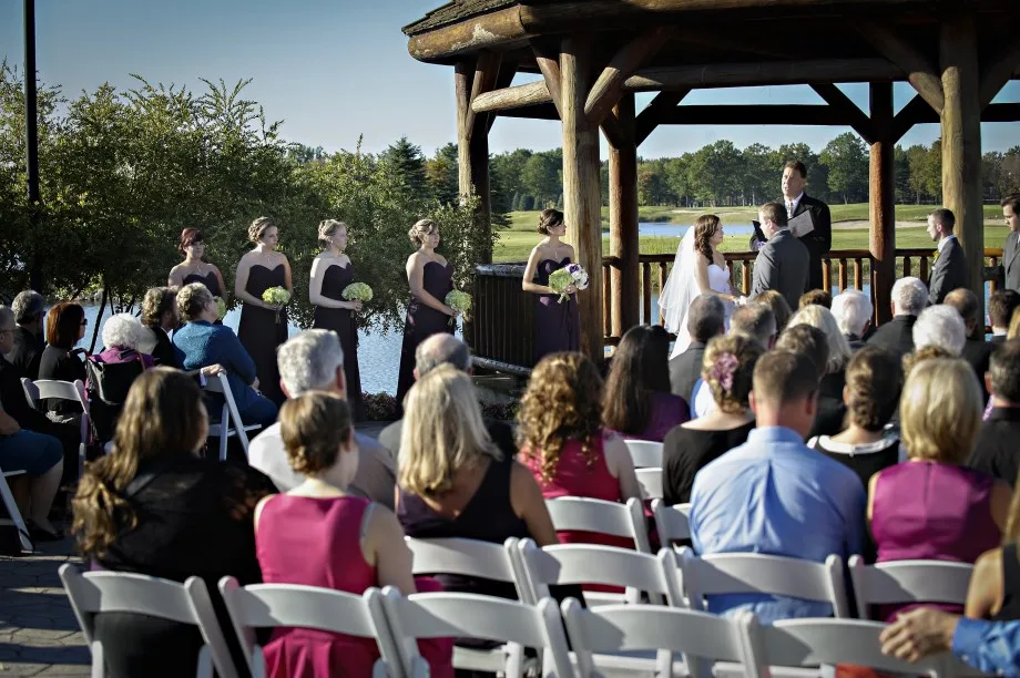 Wedding guests gathered around the waterfront gazebo at Solitude Links